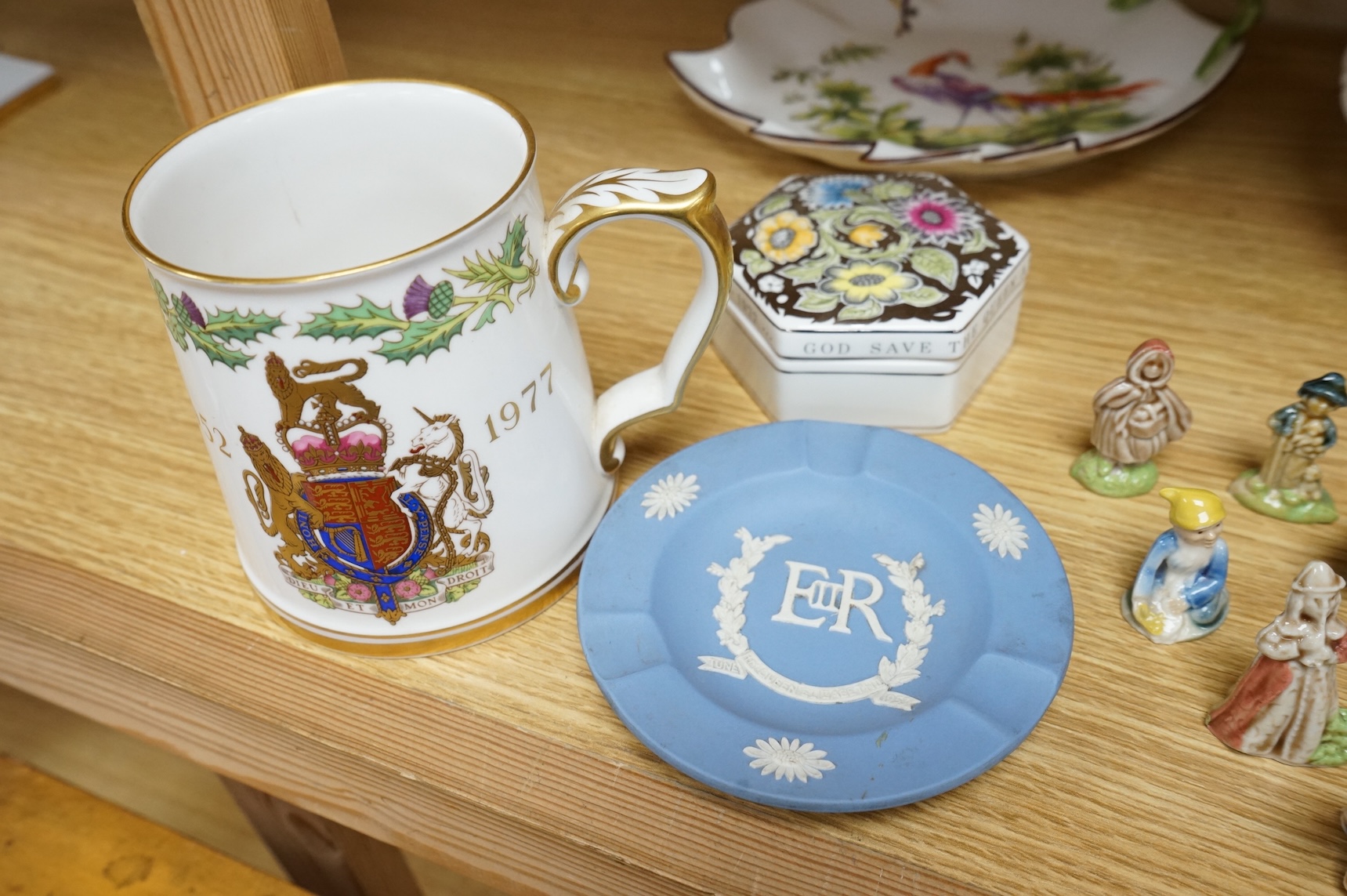 A collection of porcelain and pottery to include commemorative china, a leaf dish and group of wade figures, largest 29cm in diameter